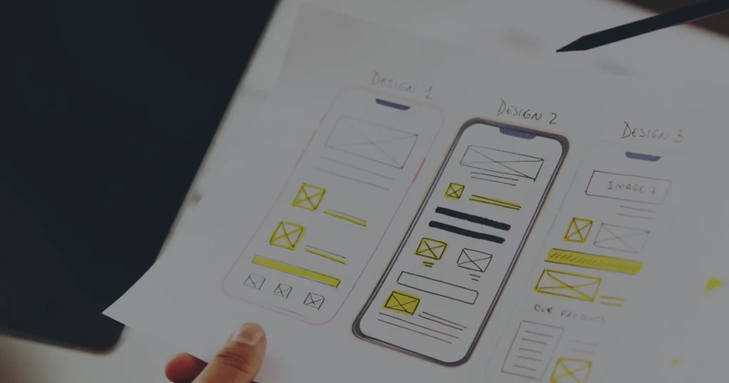 Paper showing three early mobile design wireframes